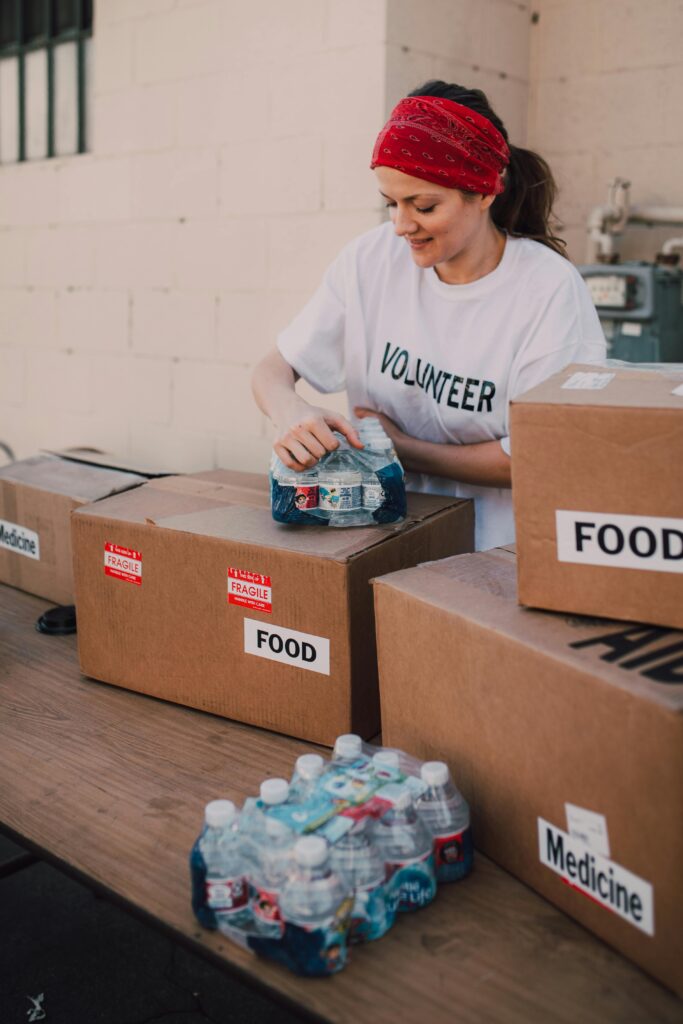 Non-profit bookkeeping volunteer packing donation boxes